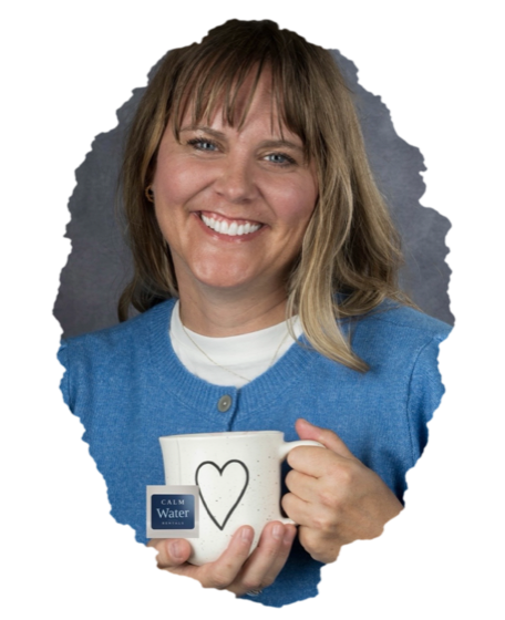 Katie Riedel of Calm Water Rentals, holding a Calm Water Rentals mug.
